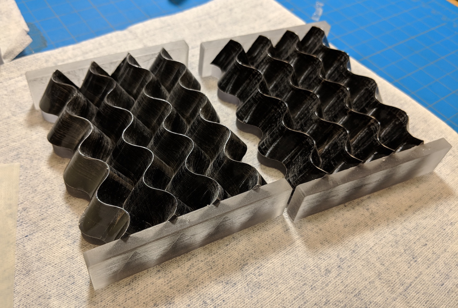 curved-crease miura-ori folds manufactured out of carbon fiber